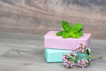 Obraz na płótnie Canvas two herbal handmade organic soap bar with mint and thyme