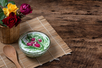 Lod Chong Thai dessert made from tapioca flour mixed with red sugar and coconut milk, sweet and delicious, decorated with roses.
