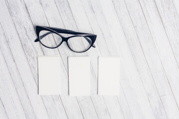 business card holders in the office blank glasses flower in a pot top view office