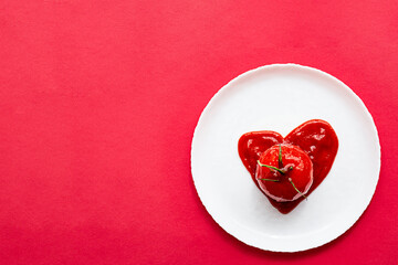 Obraz na płótnie Canvas Heart shaped tomato in tomatoes paste, on a white plate. Modern creative still life.