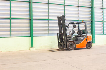 The 2.5 ton forklifts inside empty warehouse with wall background
