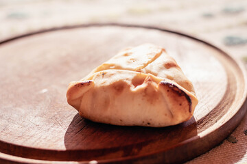 Arabic empanadas on wooden plate with natural light