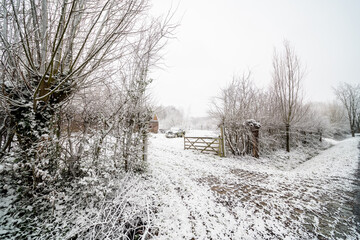 An old farm with a snowy car