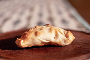 Arabic empanadas on wooden plate with natural light