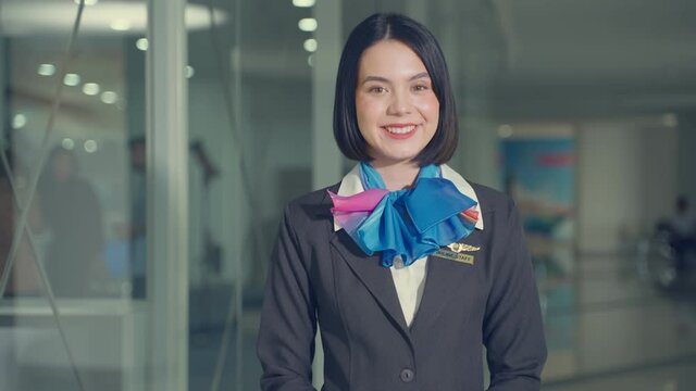 Portrait of caucasian flight attendant smiling and looking at camera.