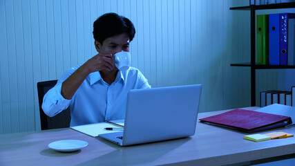 Young businessman is determined to work hard even after working overtime.