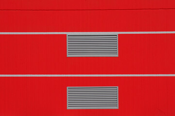 Detail of a red wall with air vents