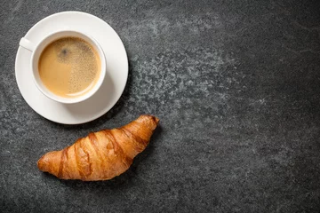 Poster Café Cup of coffee and fresh croissant on black table