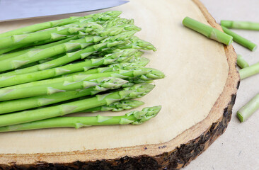Fresh green asparagus on cutting board.