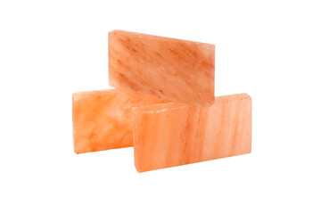 Red, pink, yellow, brown, himalayan polished salt blocks bricks on isolated white desk