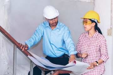 Construction engineer teamwork Safety Suit Trust Team Holding White Yellow Safety hard hat Security Equipment on Construction Site. Hardhat Protect Head for Civil Construction Engineer Concept