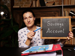 High resolution hand holding white card with written text Savings Account - closeup shot.