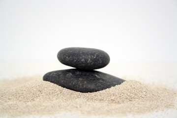 Fototapeta na wymiar Sea round stones on the fine sand. Selective focus.