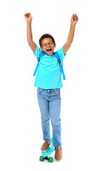 Happy little African-American schoolboy with skateboard on white background