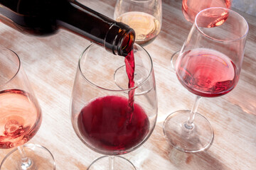 Red wine poured into a glass at a party