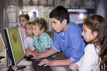 Fototapeta premium Group of friendly kids are concentrating on finding a way out of bunker quest room