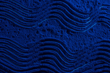 Blue spirulina powder texture on white background. Phycocyanin extract. Natural superfood, vegan, healthy dietary supplement.