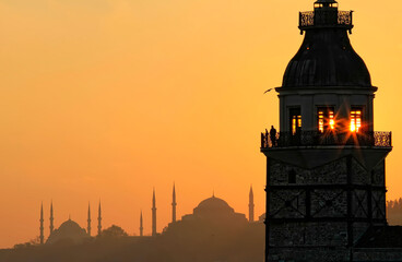 Fiery sunset over Bosphorus with famous Maiden's Tower (Kiz Kulesi) also known as Leander's Tower,...