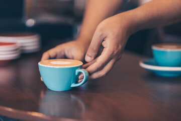 Barista serving a coffee to customer at the coffee shop.