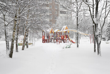 Naklejka premium Yard with children's playground during heavy snow in Russia