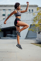 Afro athletic woman doing exercise outdoors.