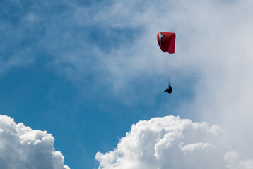 Lonely paraglider flying in the blue sky