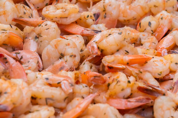 Process of grilling shrimps, prawns on brazier at summer local food market - close up view. Outdoor cooking, gastronomy, seafood, barbecue, street food concept