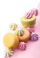 Dessert cake macaron or macaroon on pink background top view. Flat lay composition.