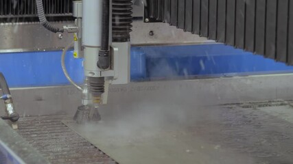 Metalworking, industrial, manufacturing, technology concept. Fast extreme cnc automatic waterjet cutting machine working with sheet metal by high-pressure water jet and abrasive substance