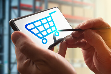 Symbol for selecting purchases on the smartphone screen. Logo with shopping cart. Shopping through the Internet. Buy products online.