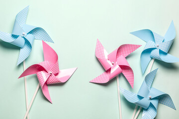 Pink blue paper spinners on light background. Kids toys colorful pinwheels on celebration party...