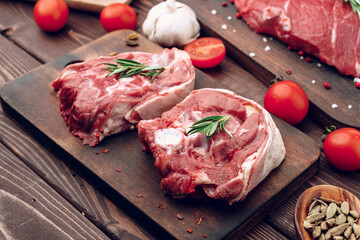 Raw meat beef shank slices on brown wooden board