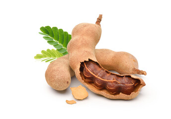 Tamarind fruits with green leaves isolated on white background.
