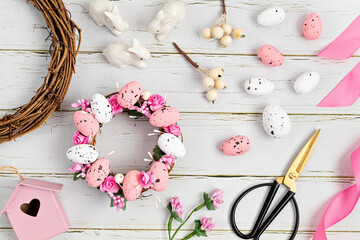 Handmade diy home interior decoration wreath with easter eggs in pink color