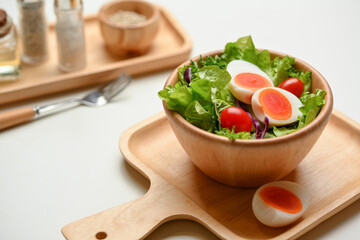 Cropped shot of a bowl of of salad with boiled eggs, lettuce and tomato