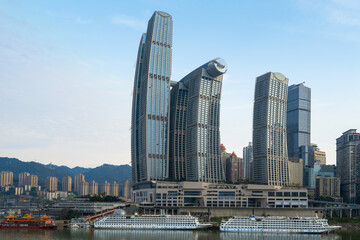 Fototapeta na wymiar Cruise ships and skyscrapers at Chaotianmen Wharf, Chongqing, China
