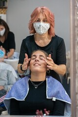 Woman giving a facial massage 