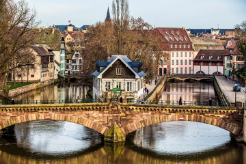 A Beautiful Bridge Over the River in Strasbourg With Apartments in the Background
