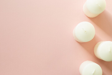 Aromatic white candles on pink background. flat lay, top view, copy space