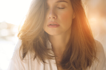 Fototapeta premium Beautiful woman. Young girl with rays of sunset bill. Portrait. High quality photo.