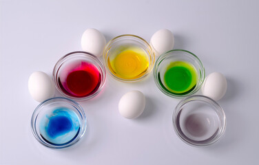 Preparation for Easter, the concept of coloring eggs, materials for coloring eggs - eggs white eggs, bowls of water and the addition of colored dyes. Step 3