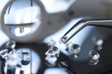 Fototapeta na wymiar Closeup of diamond stone in metal tweezers