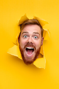 Excited Man Screaming Through Hole In Paper