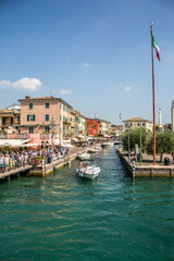 Sirmione on Lake Garda. Pier, embankment, canal with boats. Sirmione, Lombardy, Italy