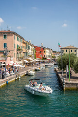 Sirmione on Lake Garda. Pier, embankment, canal with boats. Sirmione, Lombardy, Italy