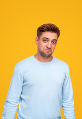 Fototapeta premium Disappointed young man looking at camera