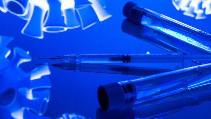 Injection bottle. Medical syringe with needle for protection flu virus and coronavirus. Covid vaccine isolated on blue. Medicine plastic vaccination equipment with needle.