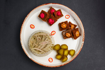 Beef tongue on a white plate, meat-in-jelly with bread with sauces and pickles.