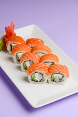 Maki Sushi - Roll made of smoked salmon and cream cheese. Traditional Japanese cuisine concept, over pastel purple.