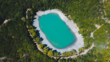 Top view of a blue lake in the middle of a green forest in Crimea near the city of Yalta